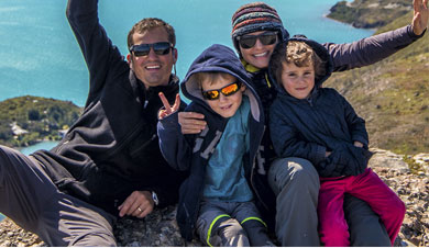 The Oliveria Family in their happy place, outside near a alpine lake.