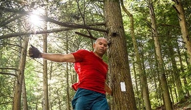 Dan Kosick exploring on a sunny day in the woods.