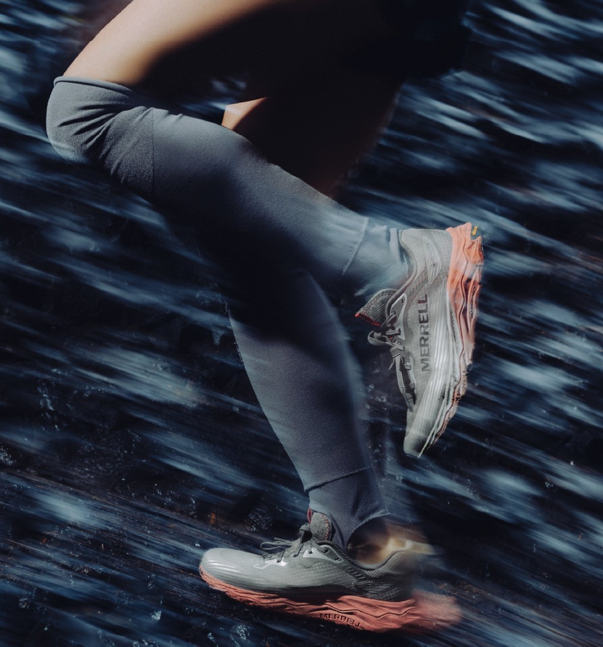 Trail runner in motion wearing Merrell running shoes