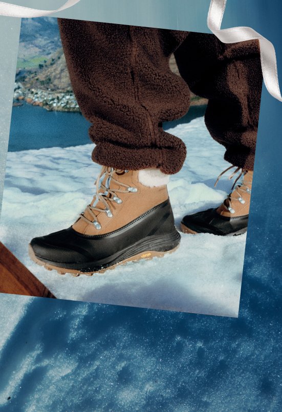 Woman wearing Merrell Siren 4 Thermo Lace boots in a snowy landscape.
