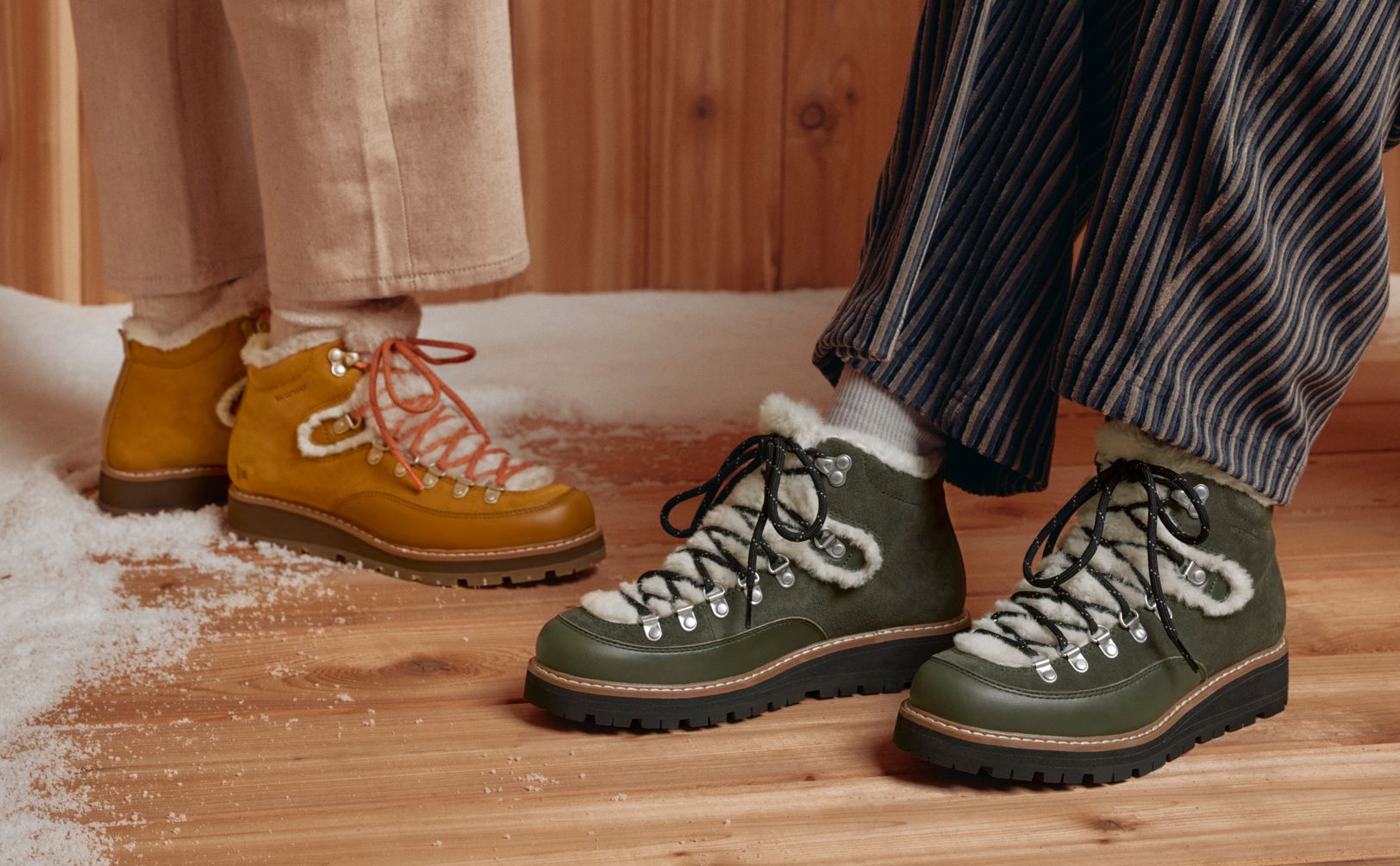 Two people wearing tan and green Merrell Sugarloaf shoes.